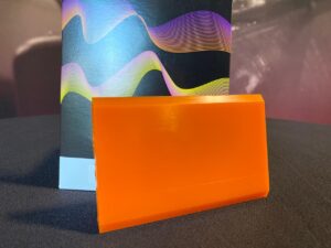 A close up of an orange plastic surface