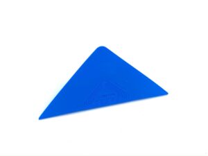 A blue triangle is laying on the ground