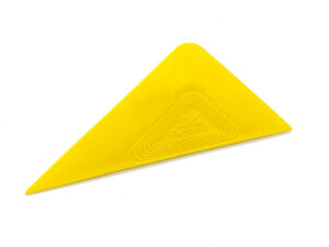A yellow triangle shaped object with a cross on it.