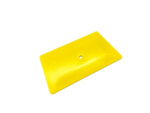 A yellow plastic object with holes in it.