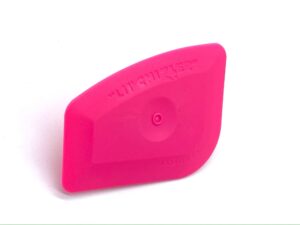 A pink object is sitting on top of the floor.