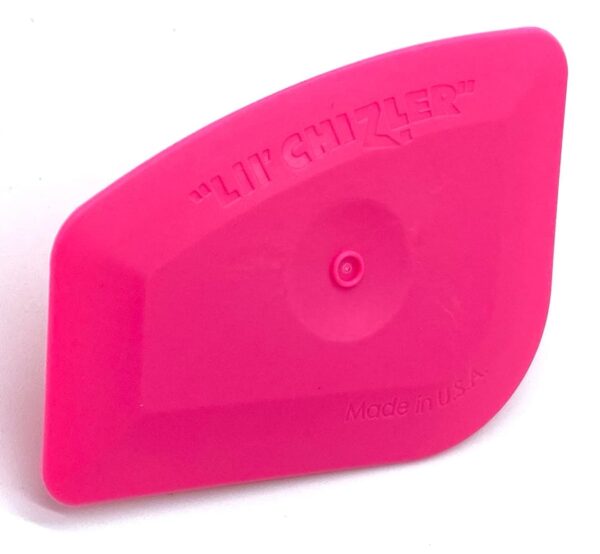 A pink object is sitting on top of the floor.