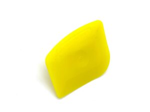 A yellow object is sitting on top of the floor.