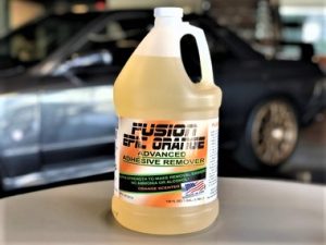 A gallon of orange adhesive remover is sitting on the counter.