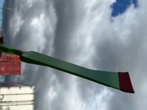 A green metal structure with a sky background